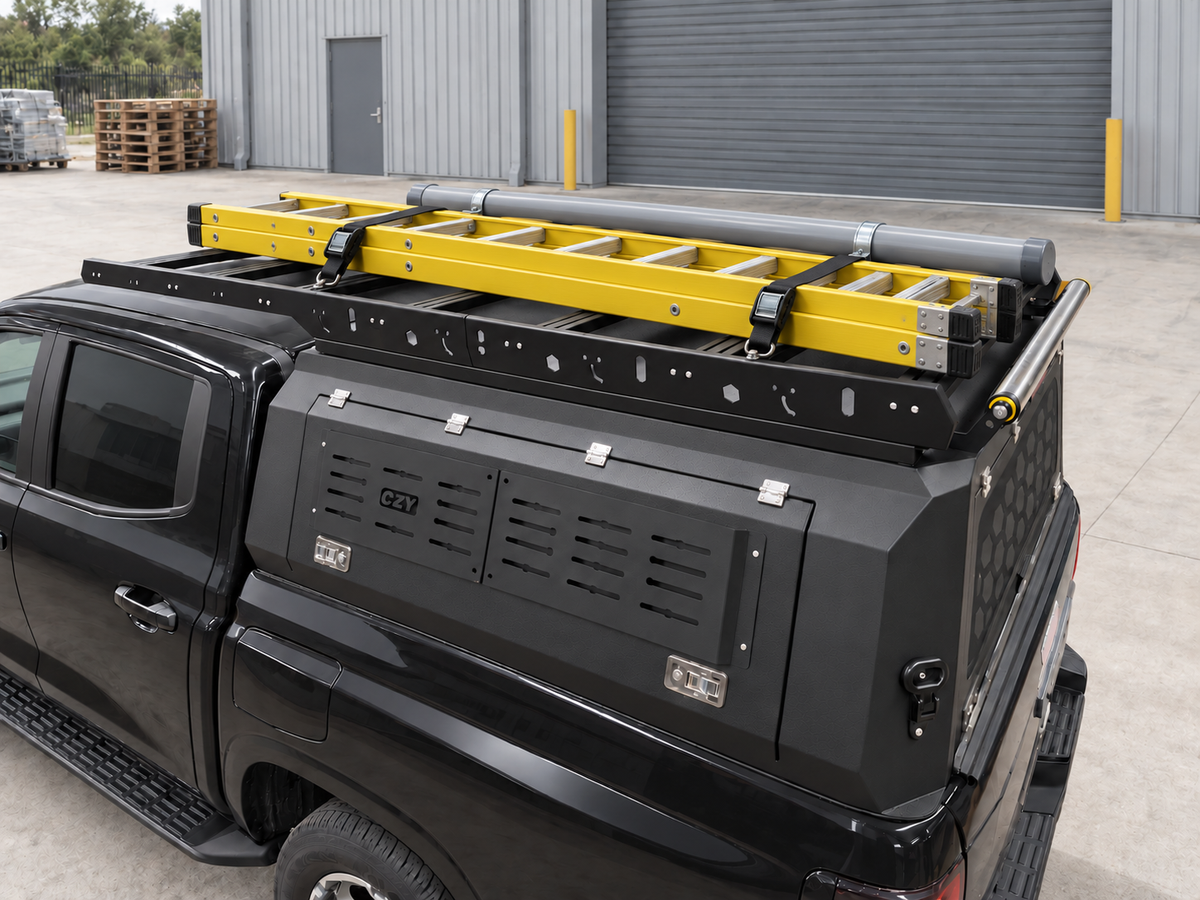 Illustrative electrician setup on the CZY Trade Canopy with a straight industrial ladder, two anchored tie-down straps and a clamped conduit carrier; accessories not included