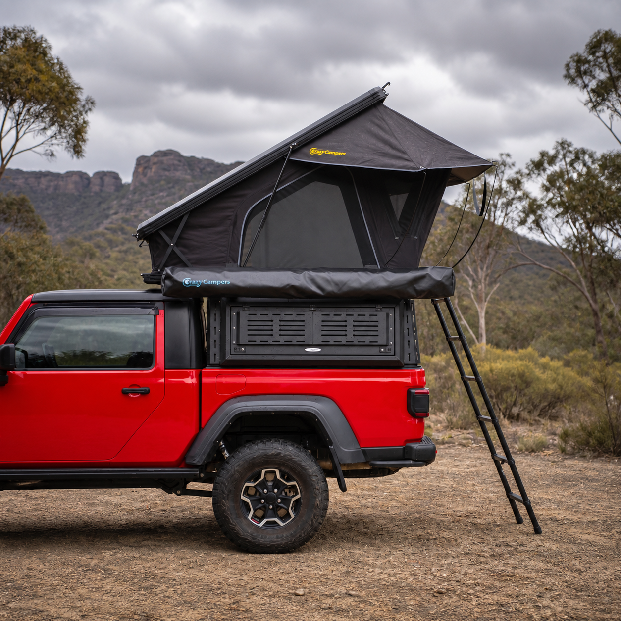 Older Version Overland X 1380 rooftop tent open on a red Jeep at a Grampians campsite