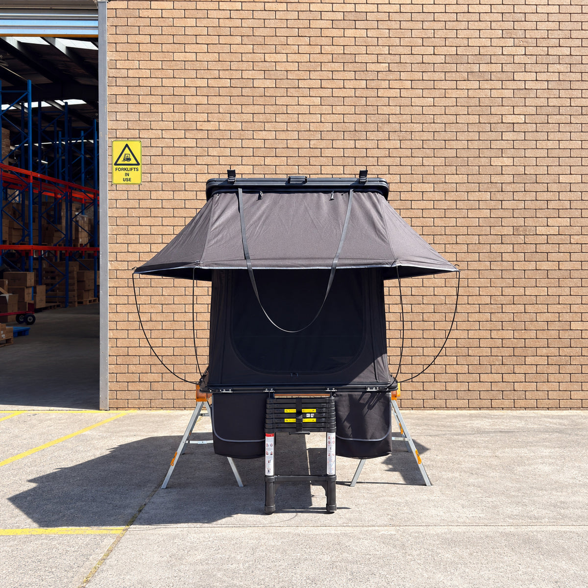 Front view of the CZY AIR rooftop tent, ladder and bags on the original ToughBuilt sawhorses and timber frame.