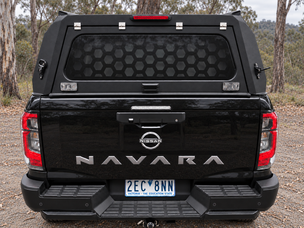 CZY Trade Canopy rear hatch closed at a High Country campsite, showing tinted rear glass and internal honeycomb screen
