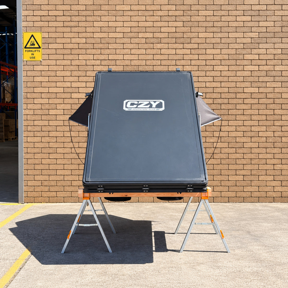 Rear CZY shell view of the AIR rooftop tent on the original ToughBuilt sawhorses and timber frame.