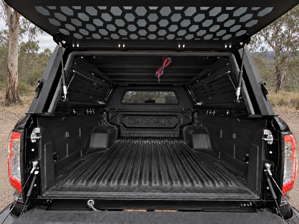 CZY Trade Canopy rear hatch open at a High Country campsite, showing the empty tub and internal reinforcement ribs