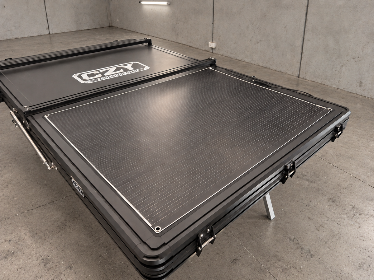 200W flexible solar panel installed on a closed rooftop tent, shown in a warehouse