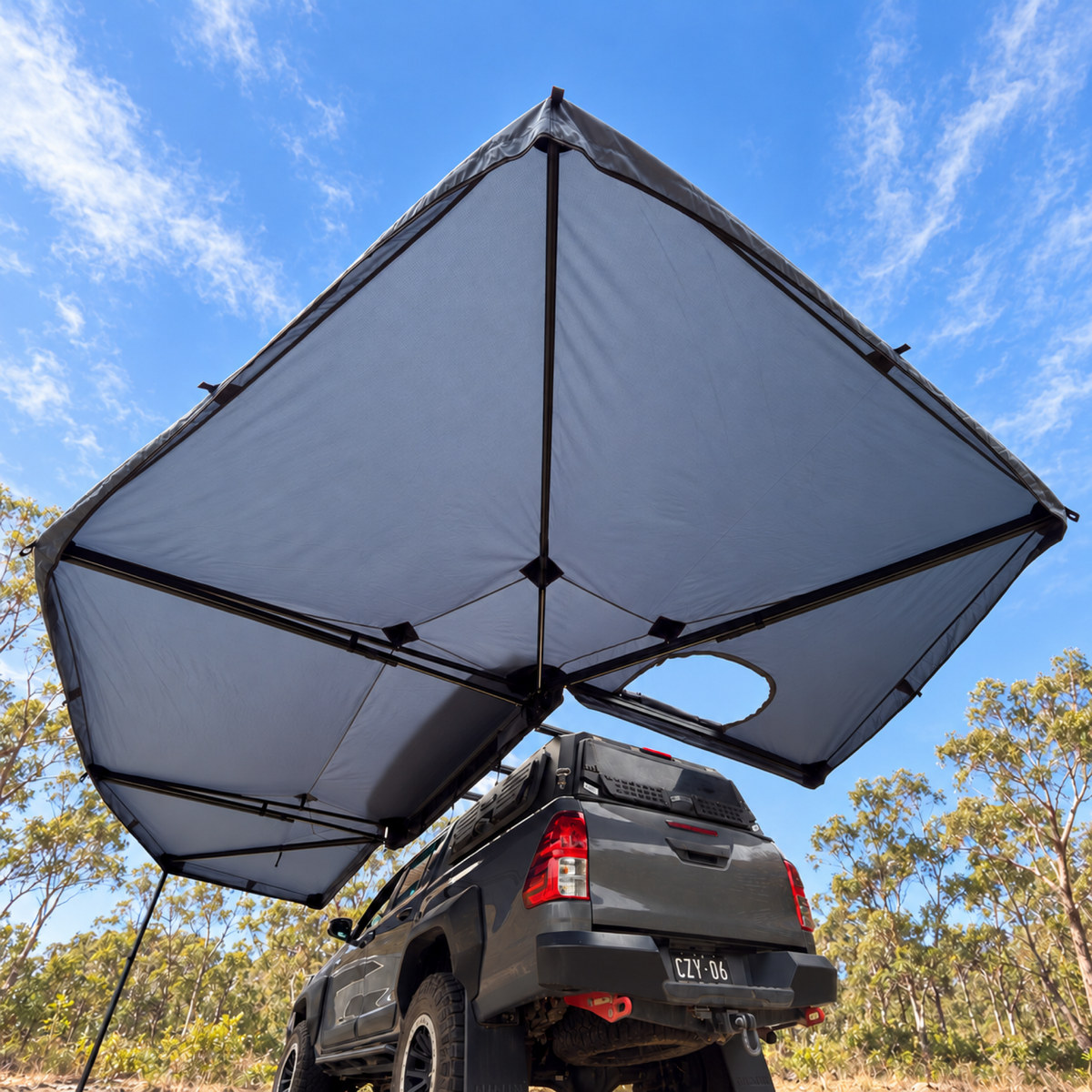 Low view of the XL 270+ Awning canopy opened over a ute